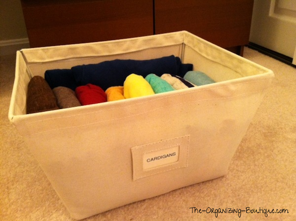 Looking for ways to organize cardigans for women? I file them in open canvas storage bins for easy access. Check it out here!